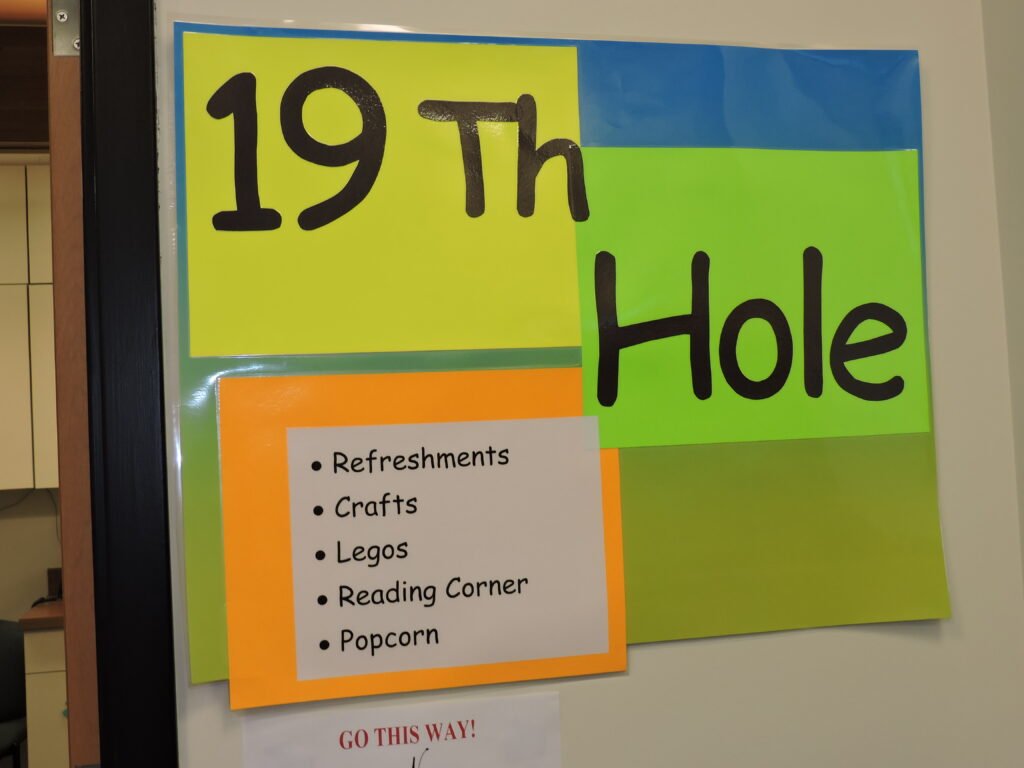 Sign showing 19th hole with snacks and other activities
