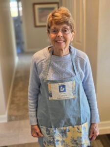 Woman with red hair and Friends of the Library apron