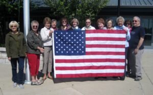Friends of the library poses with new American Flag for the library.