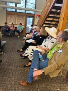 Four men and four women are suspects in a murder mystery game and listen to instructions.